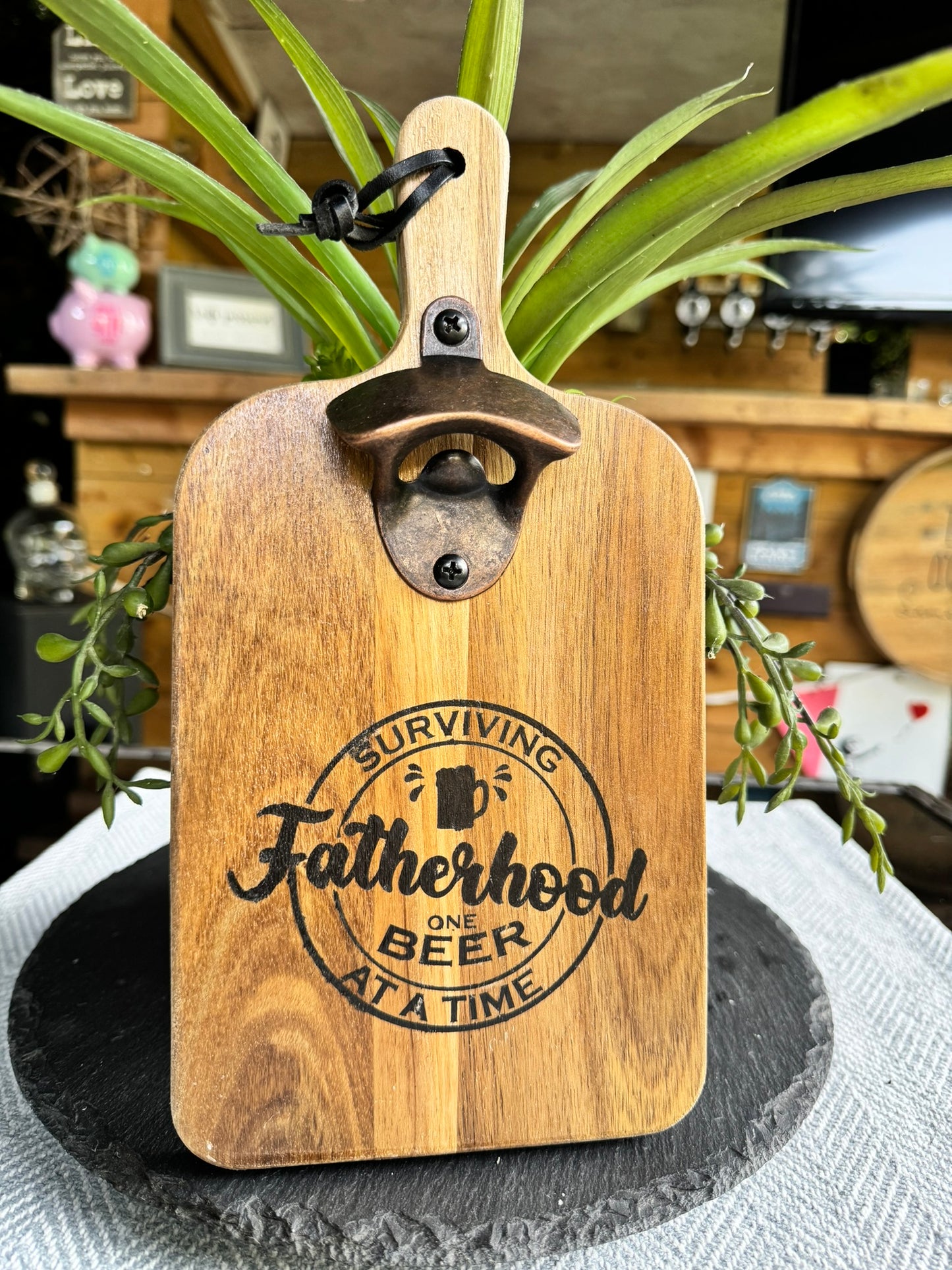 Wooden bottle opener 'SURVIVING FATHERHOOD ONE BEER AT A TIME'