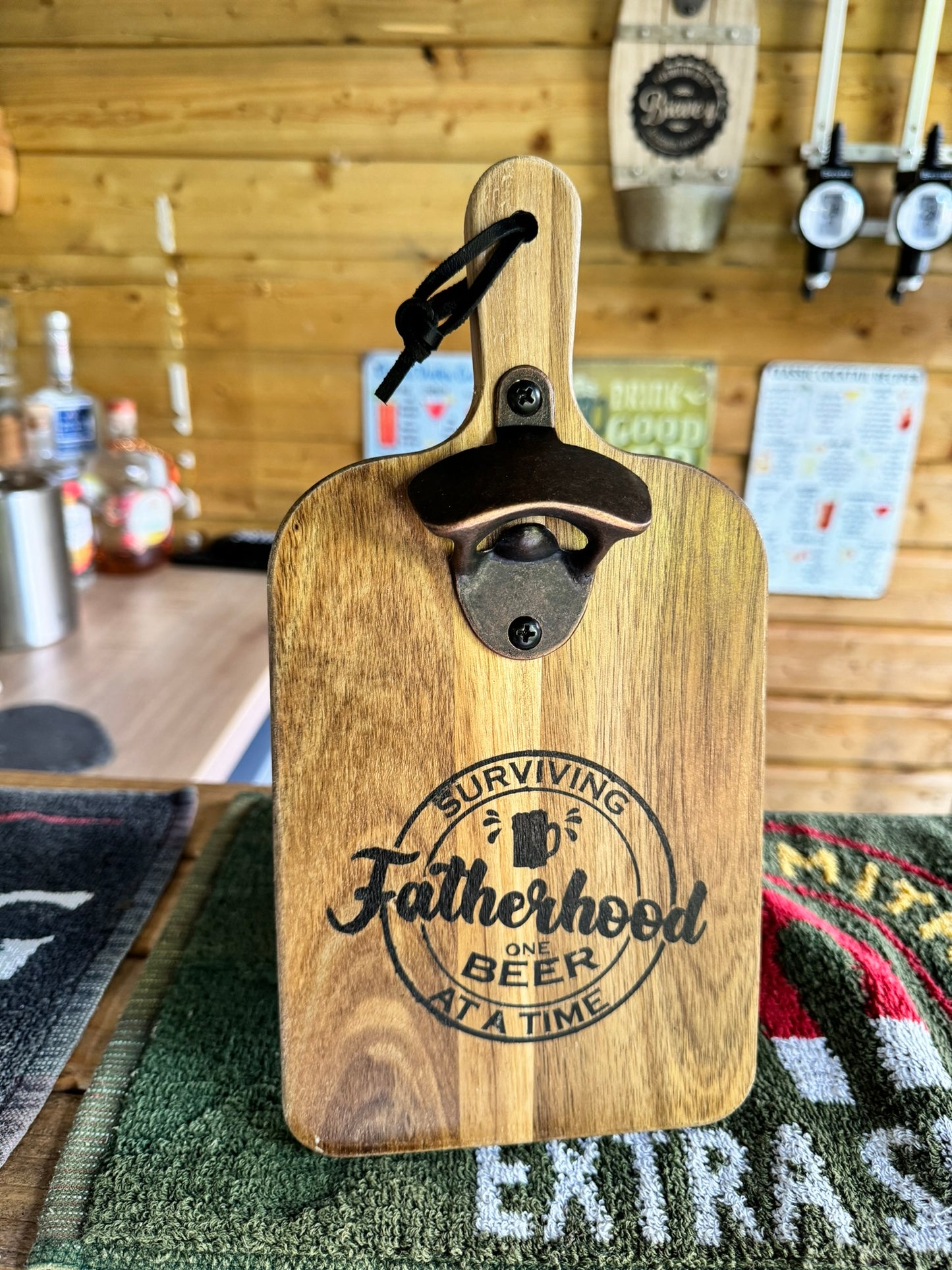 Wooden bottle opener 'SURVIVING FATHERHOOD ONE BEER AT A TIME'