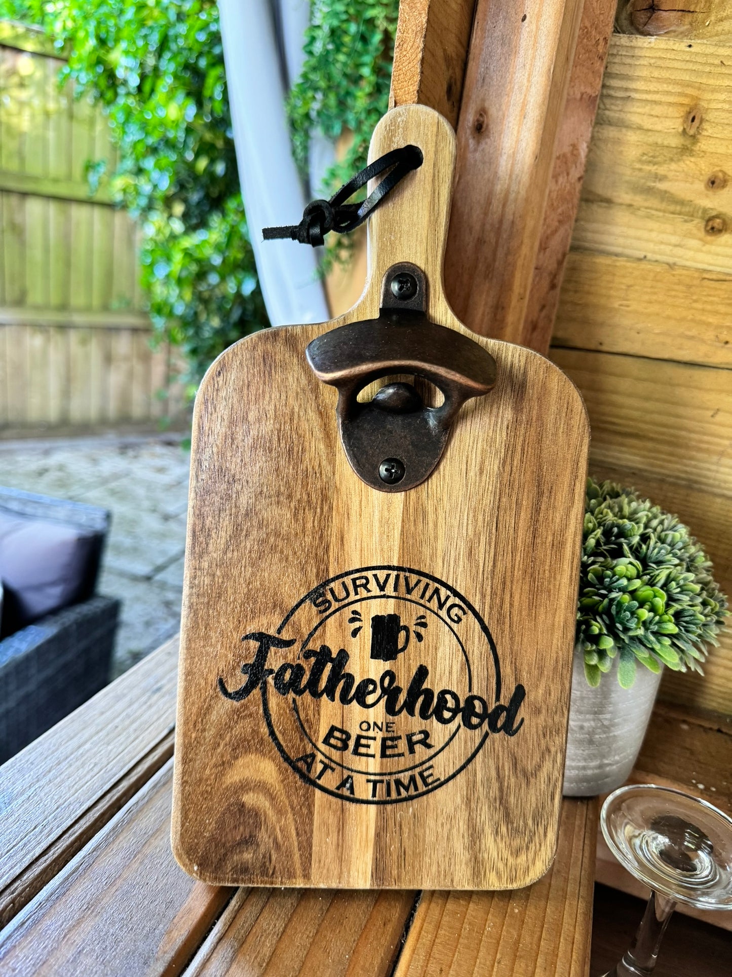 Wooden bottle opener 'SURVIVING FATHERHOOD ONE BEER AT A TIME'