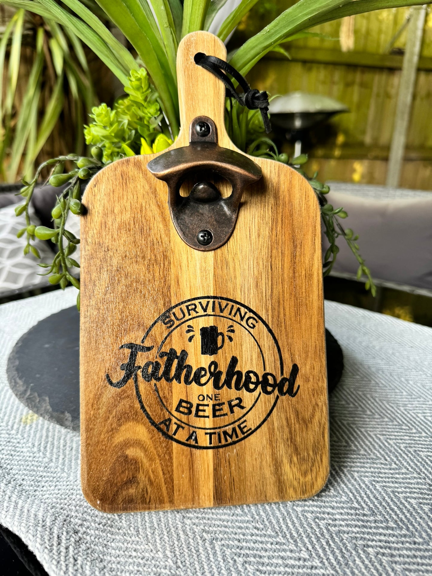 Wooden bottle opener 'SURVIVING FATHERHOOD ONE BEER AT A TIME'