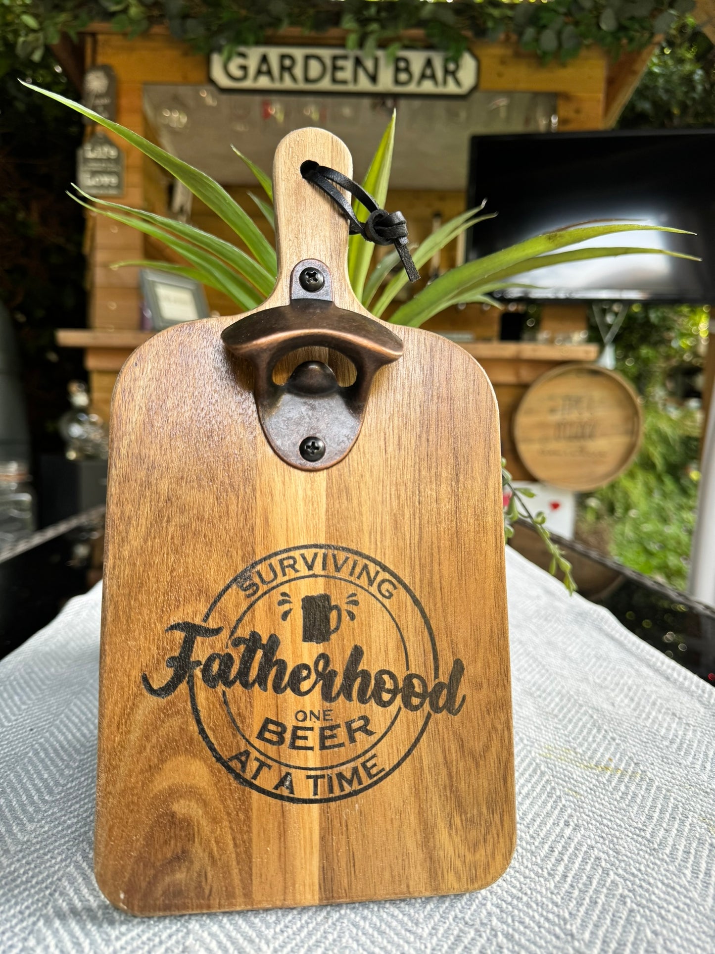 Wooden bottle opener 'SURVIVING FATHERHOOD ONE BEER AT A TIME'